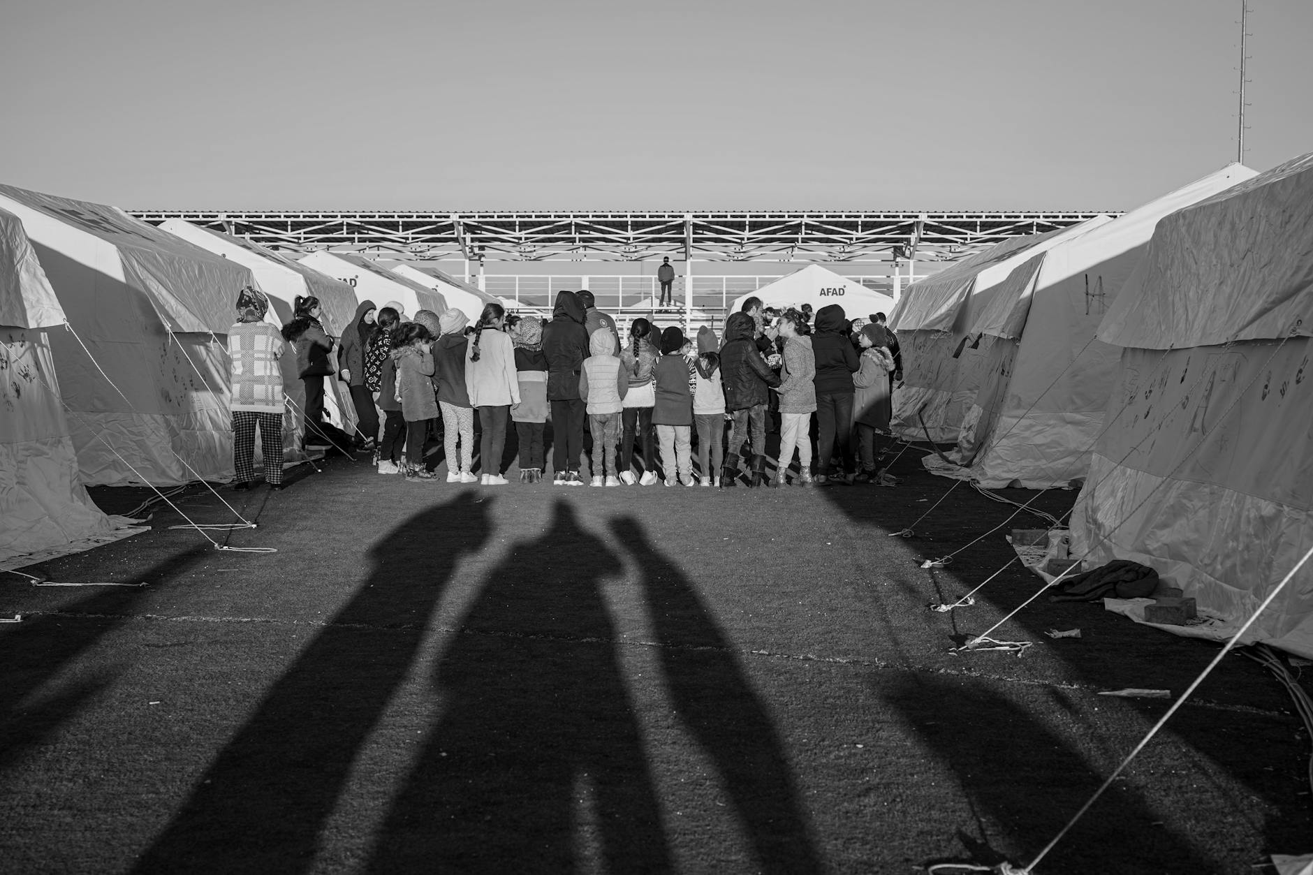Refugee camp in eastern Chad with temporary shelters and humanitarian aid workers